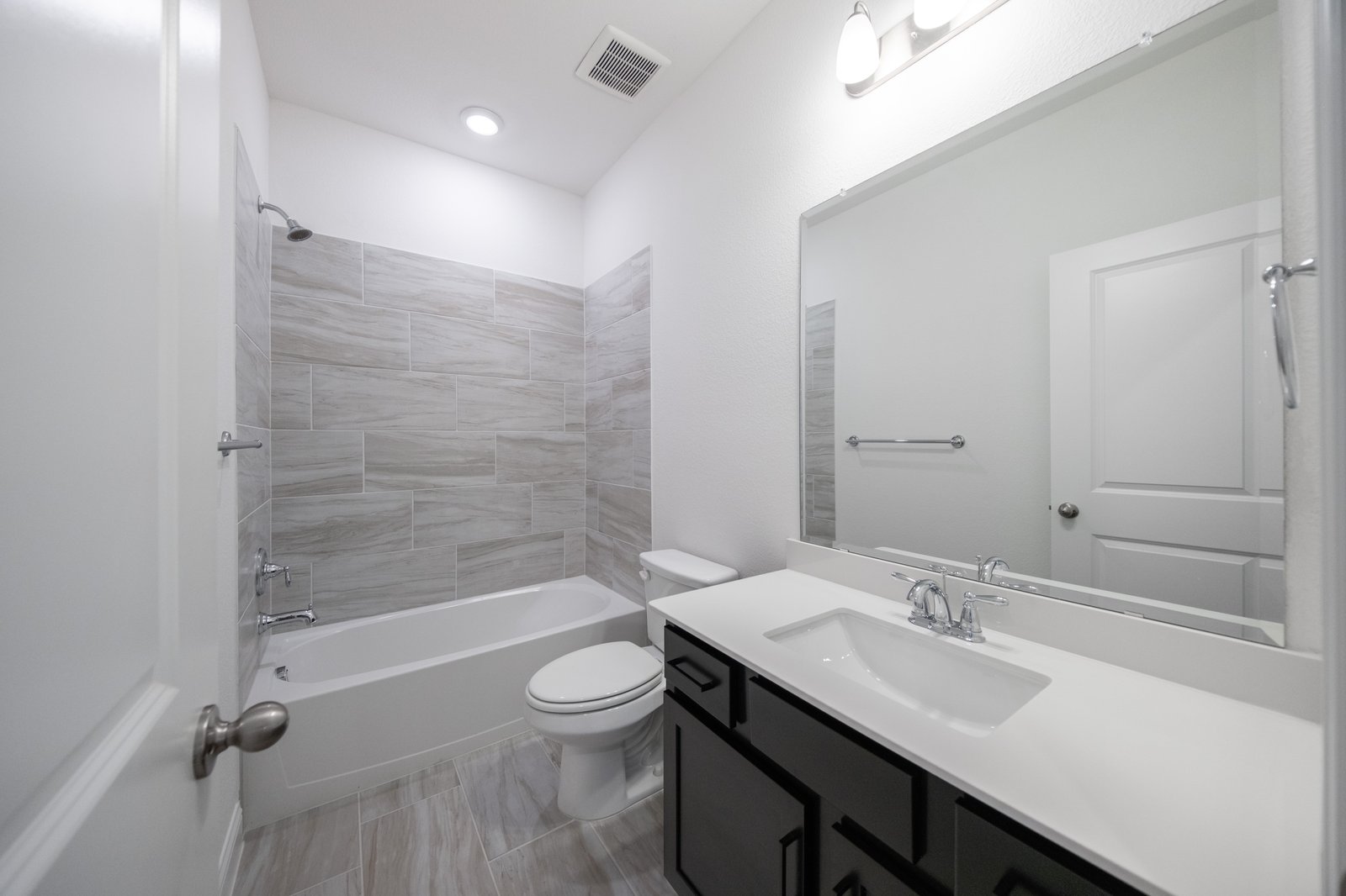 bathroom with tub and tile