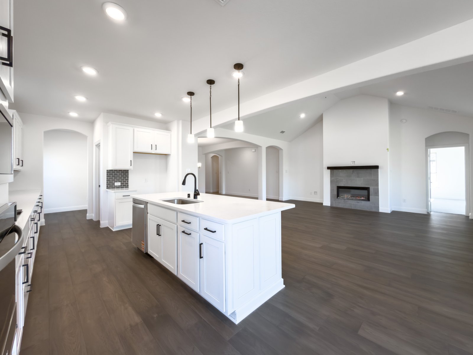 open kitchen and white cabinets and wood floors