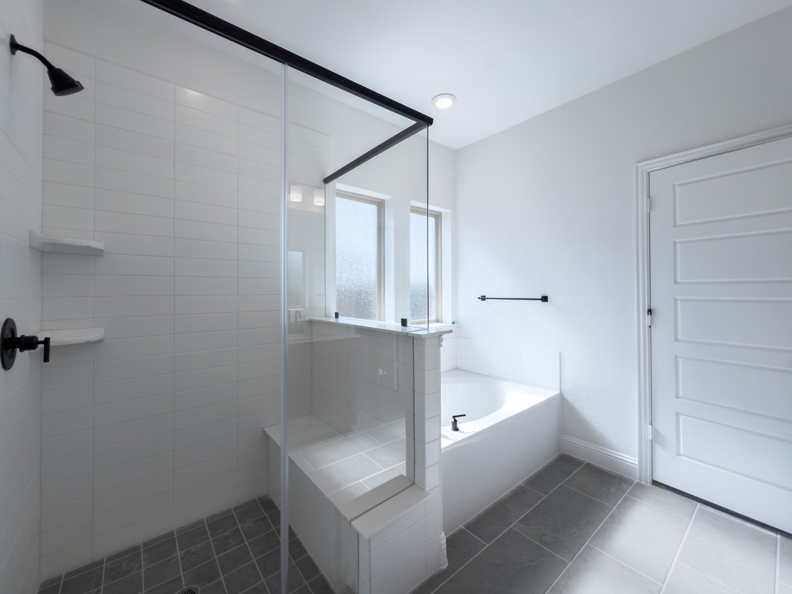 primary bathroom with walk-in shower and soaking tub