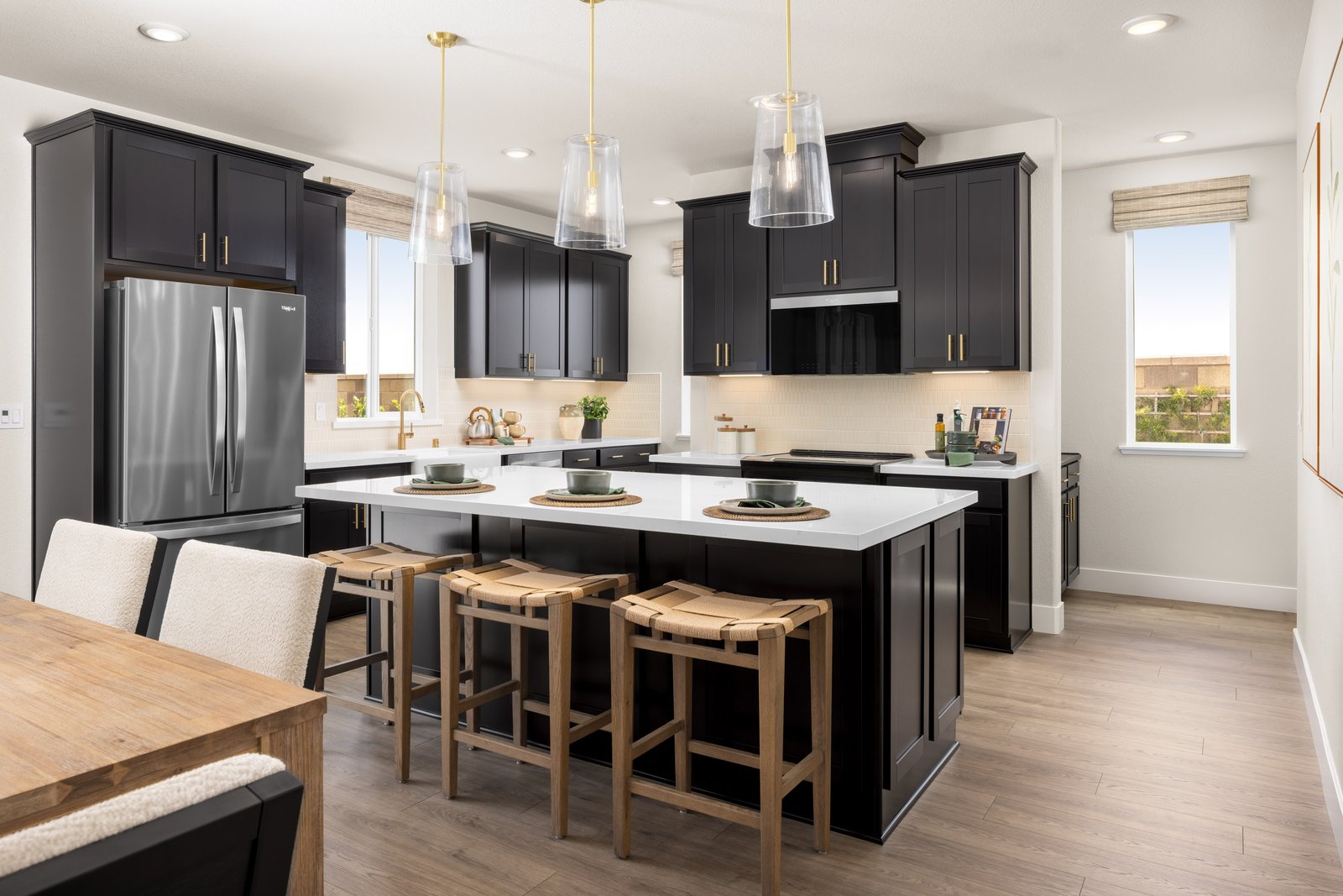 open-concept kitchen with black cabinets