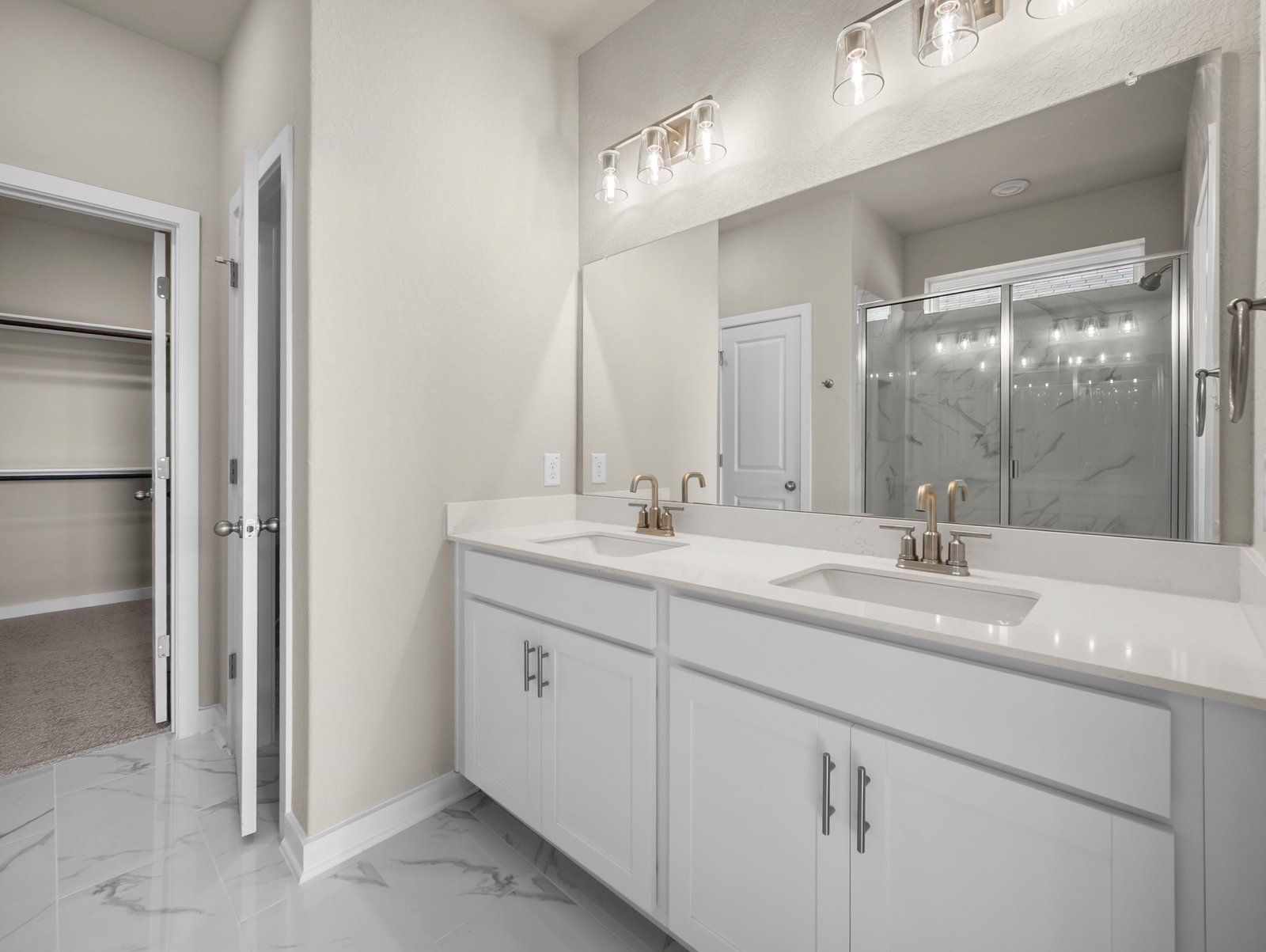 bathroom with dual sinks & a walk-in shower