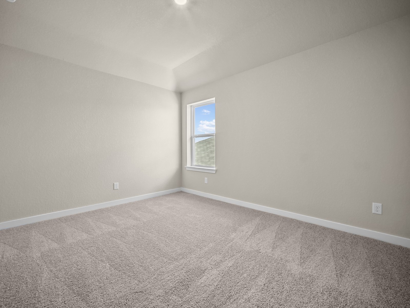 bedroom with carpet, sloped ceiling & a window