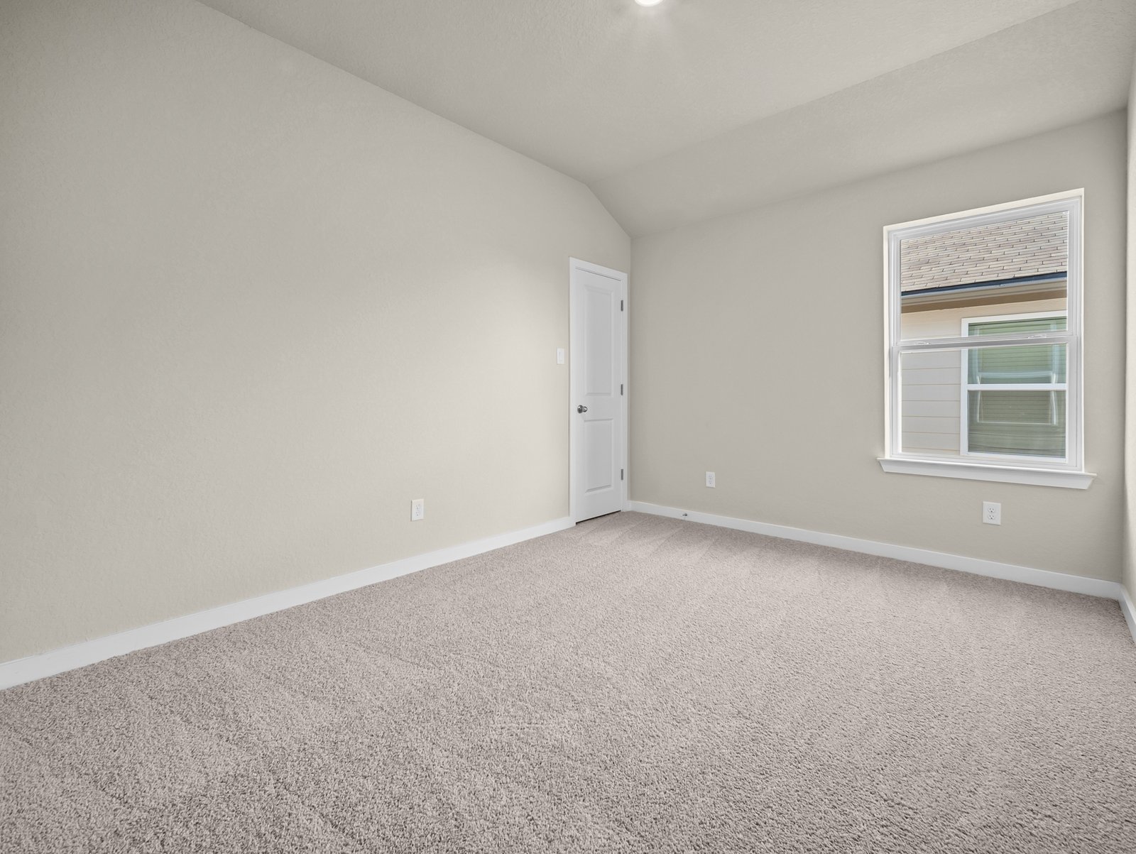 bedroom with carpet, sloped ceiling & a window