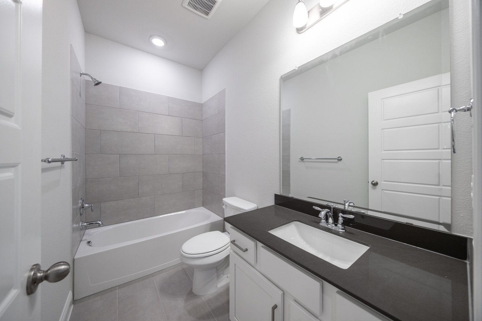 bathroom with tub and tile