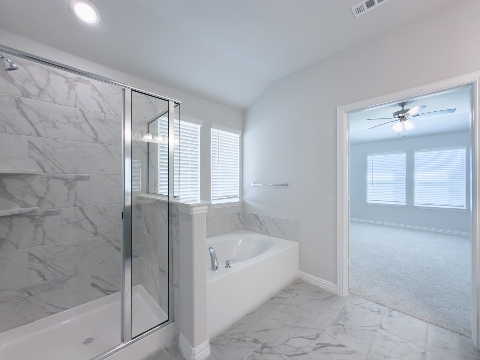 bathroom with large soaking tub and walk-in shower