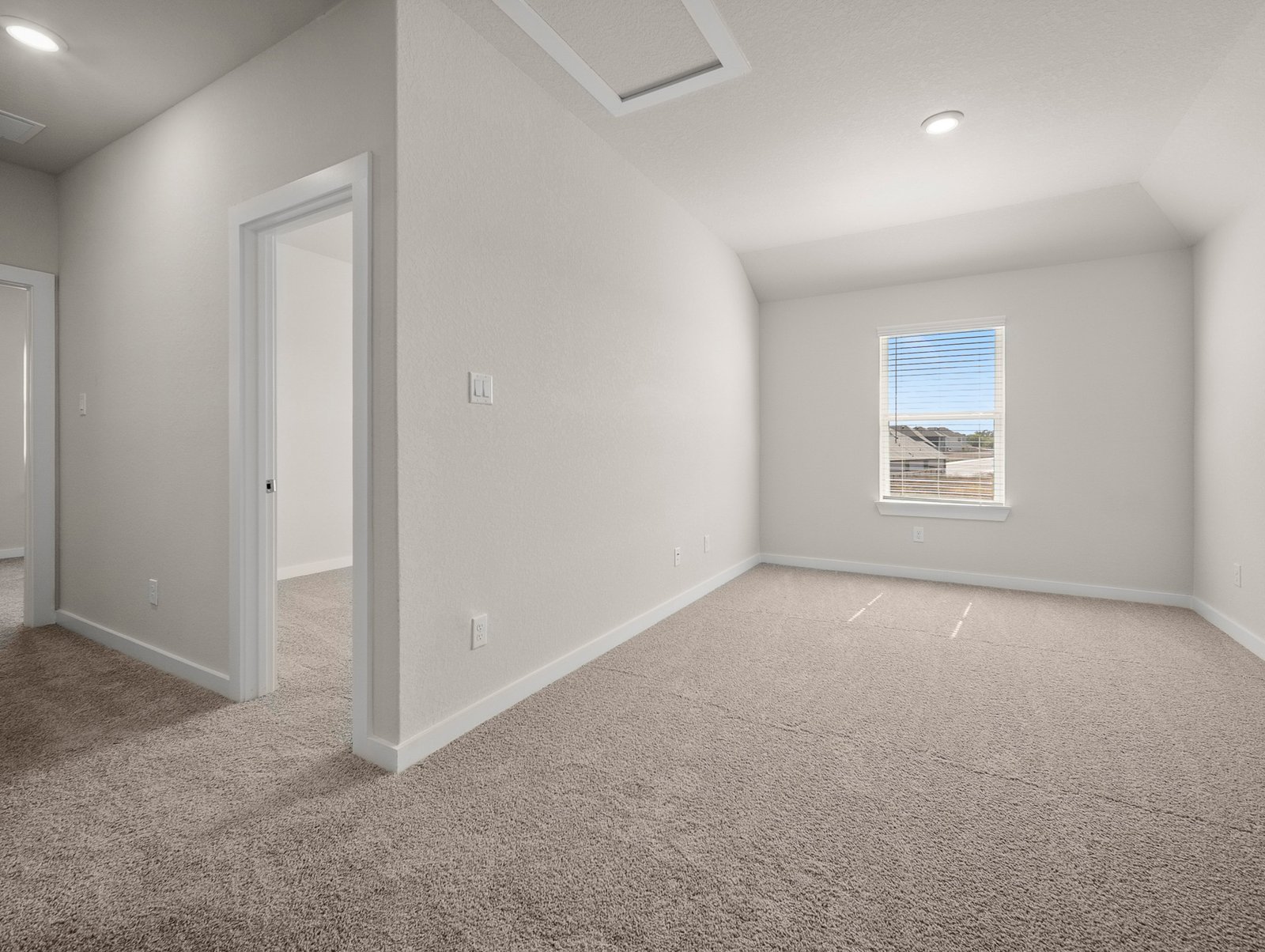 loft with carpet, recessed lighting & a window