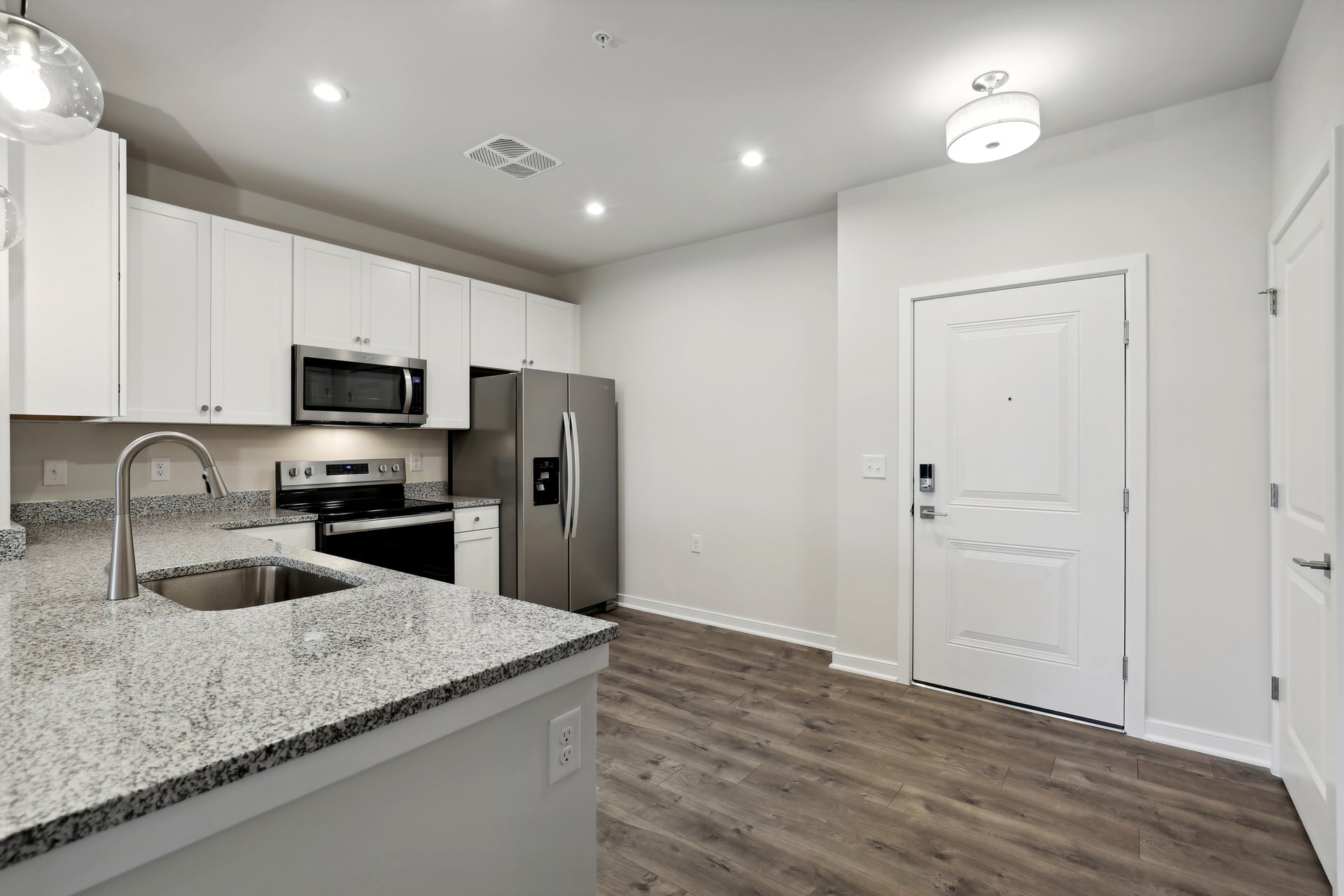 kitchen with quartz countertops and white cabinets
