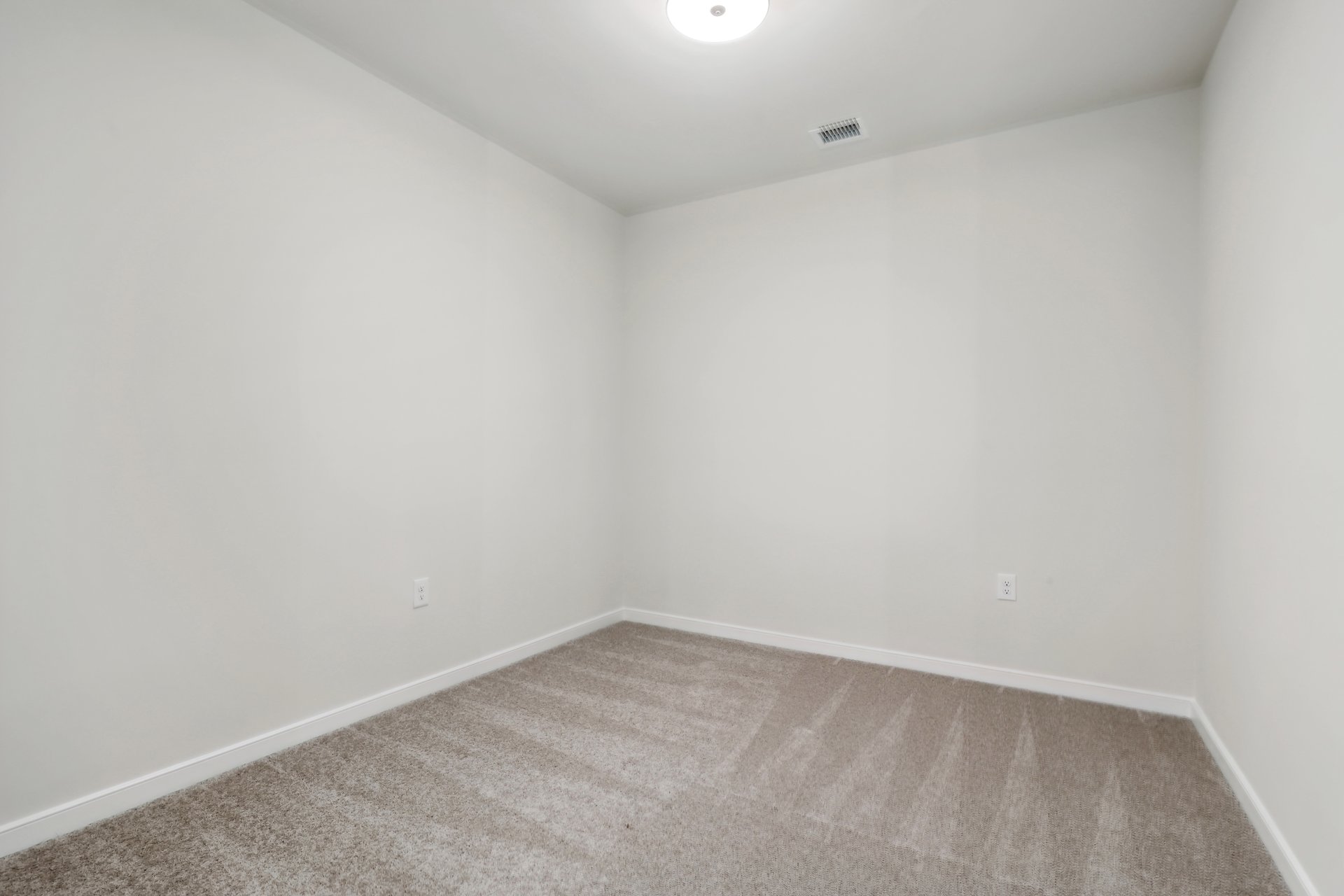 office with carpet and overhead light