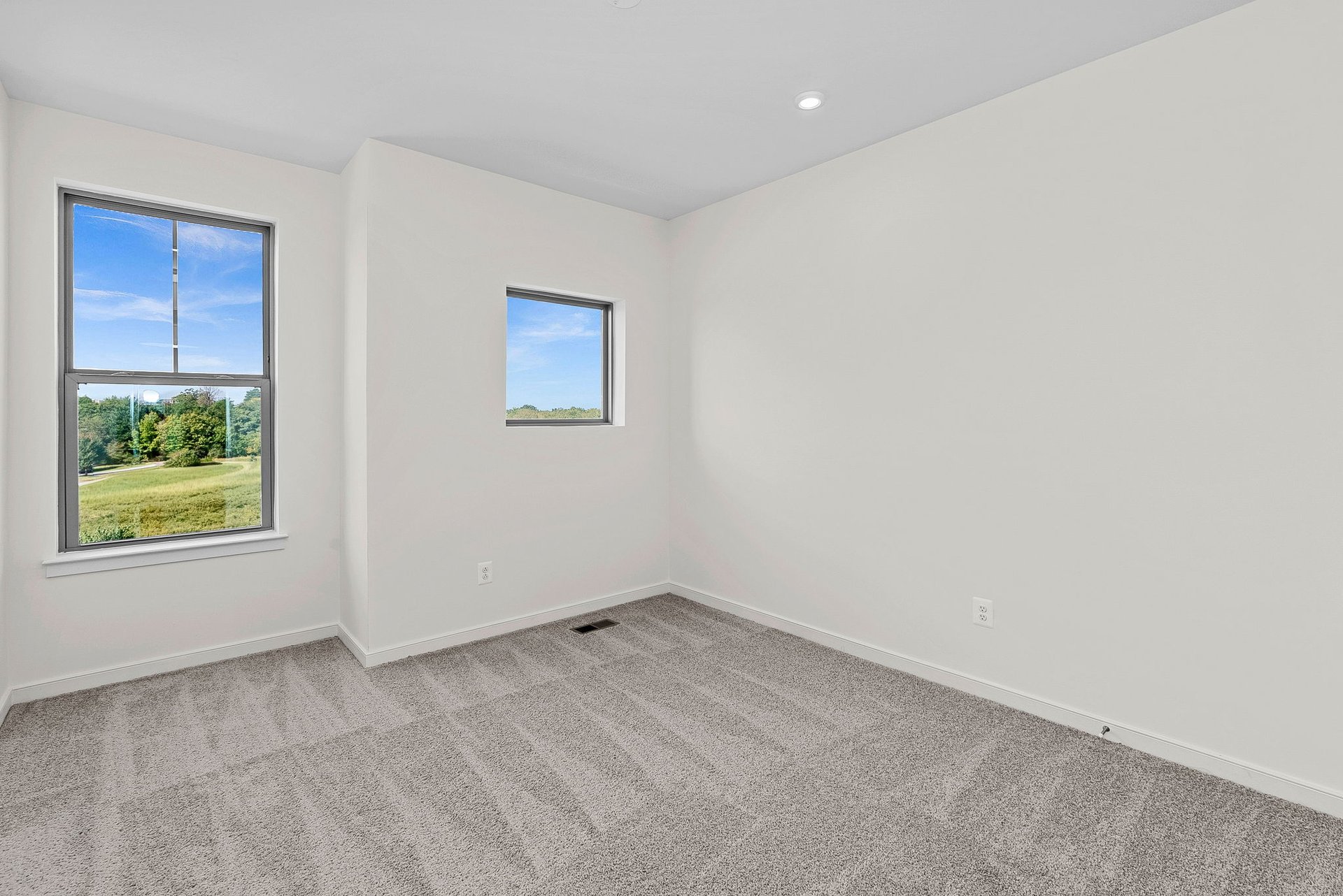secondary bedroom with two windows