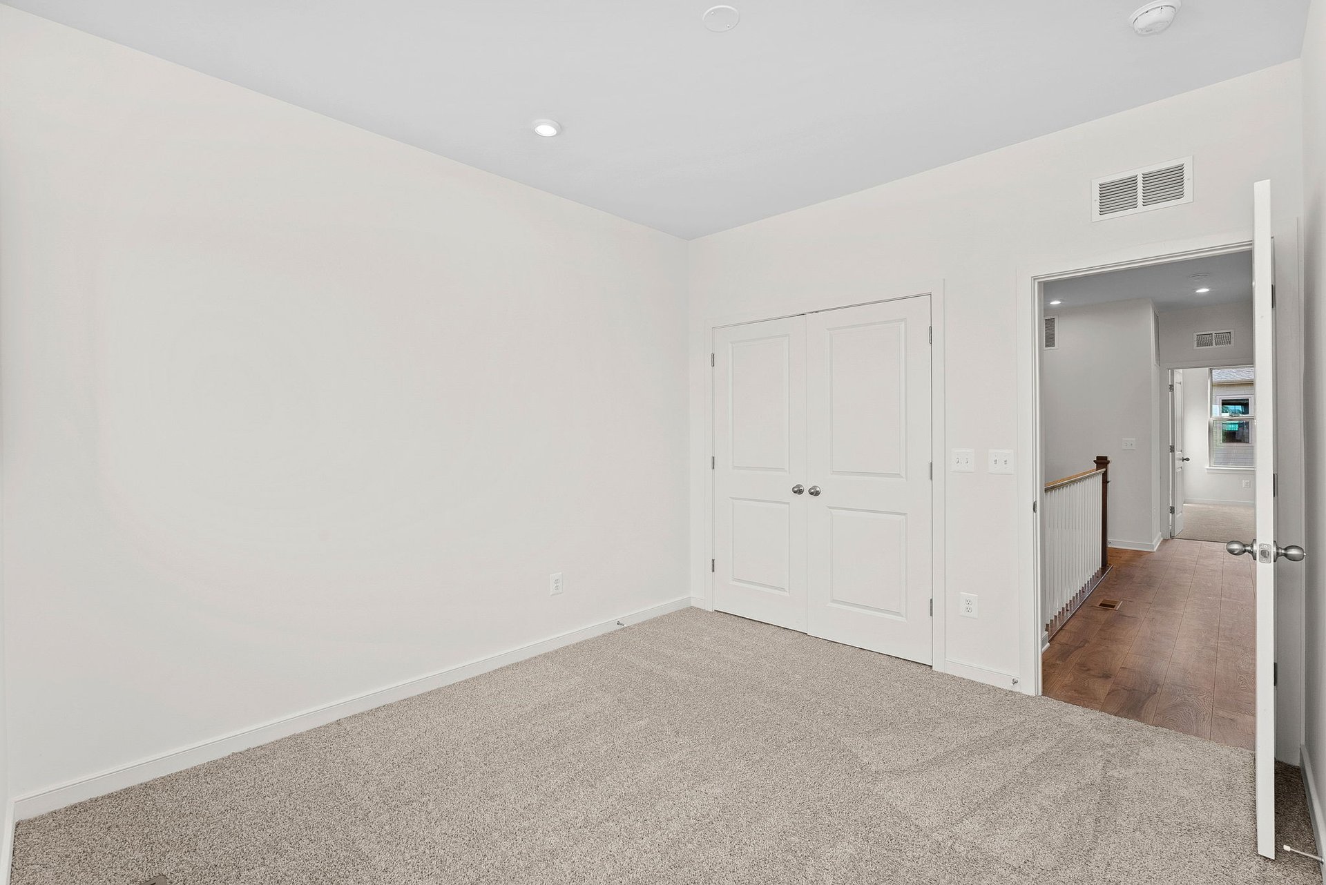 secondary bedroom with two doors to closet and hallway