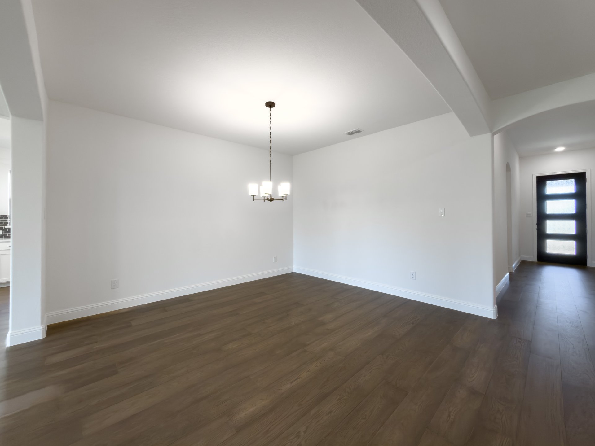 open dining room with wood floors 