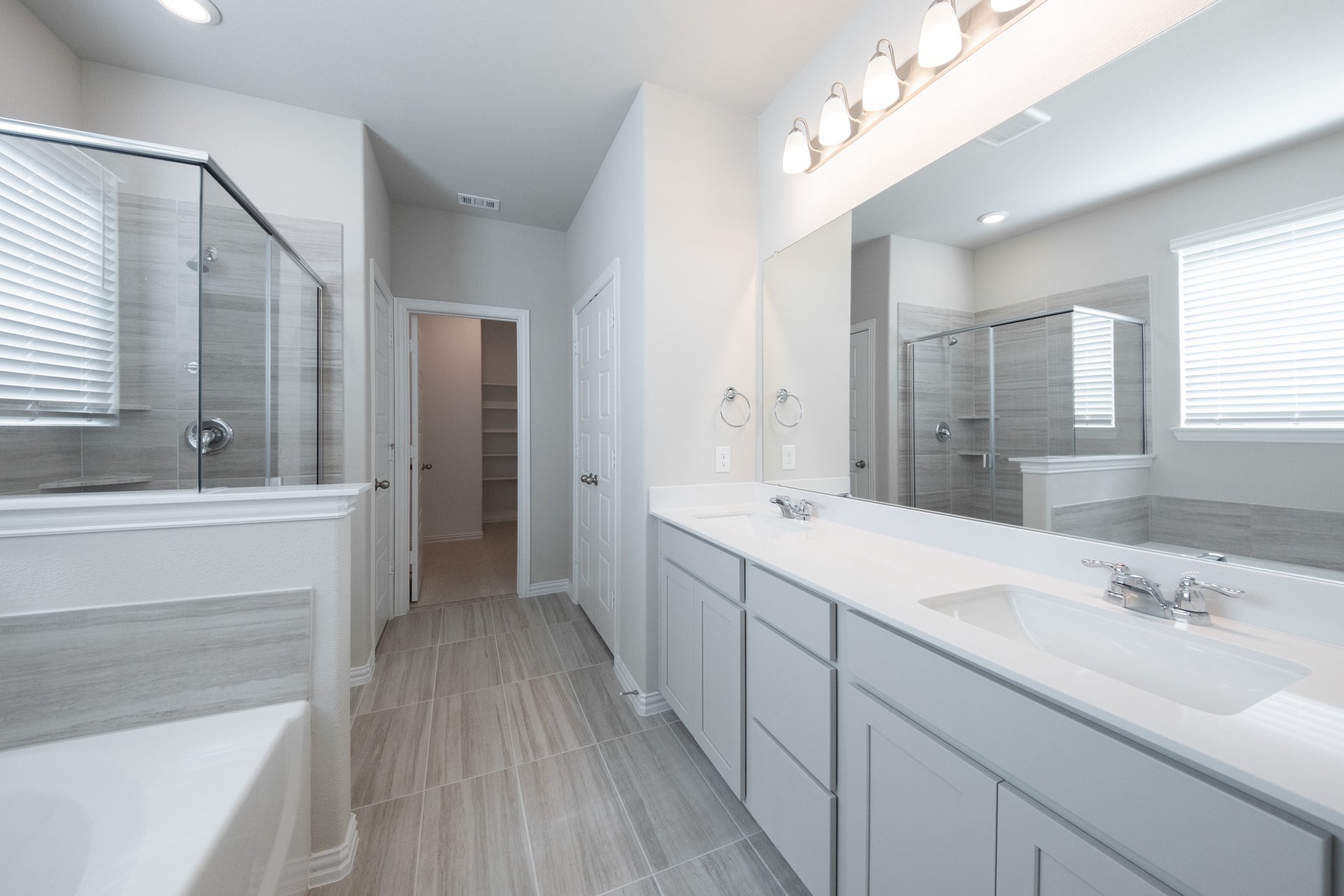 spacious primary bathroom with double sinks