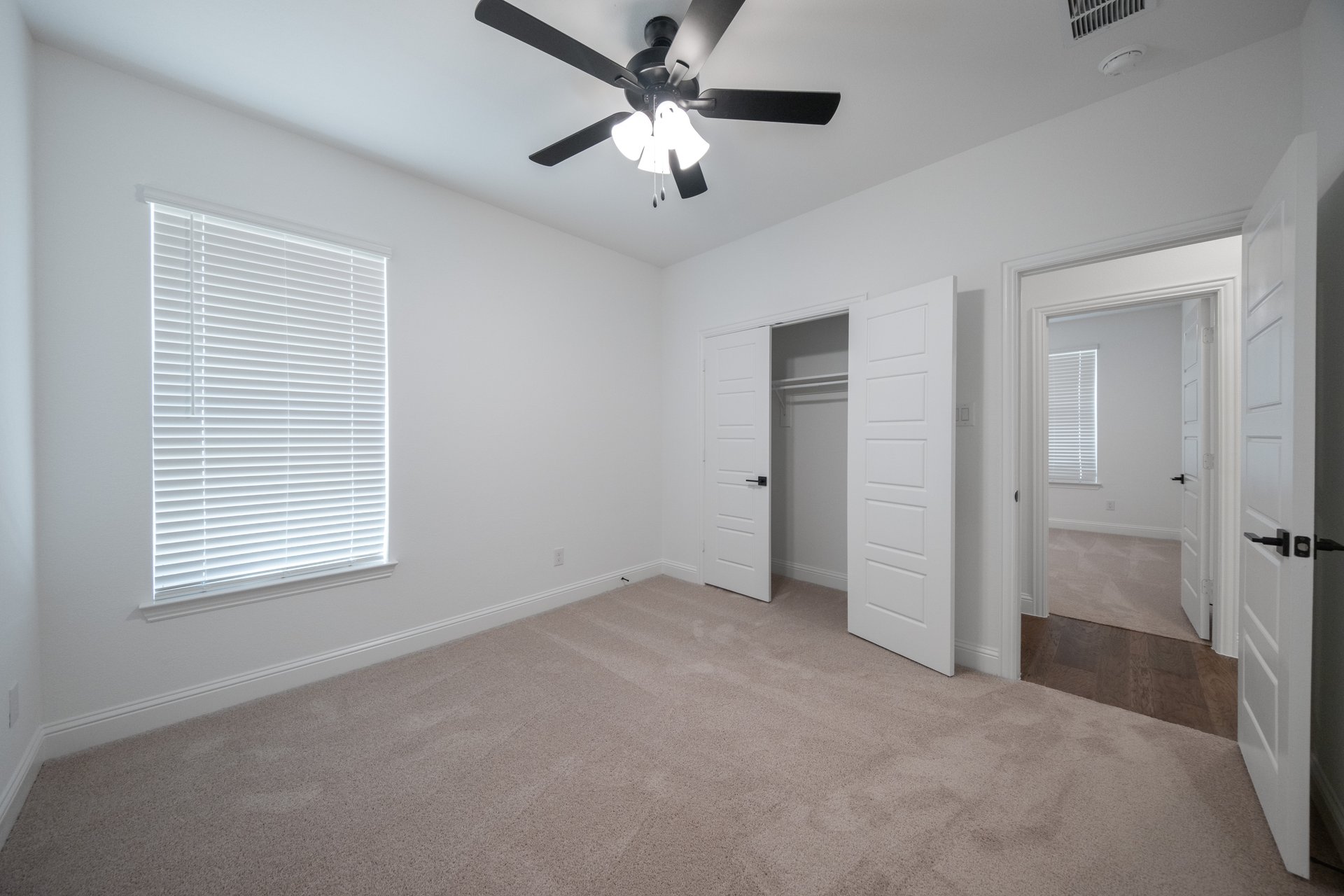 guest bedroom with carpet and window