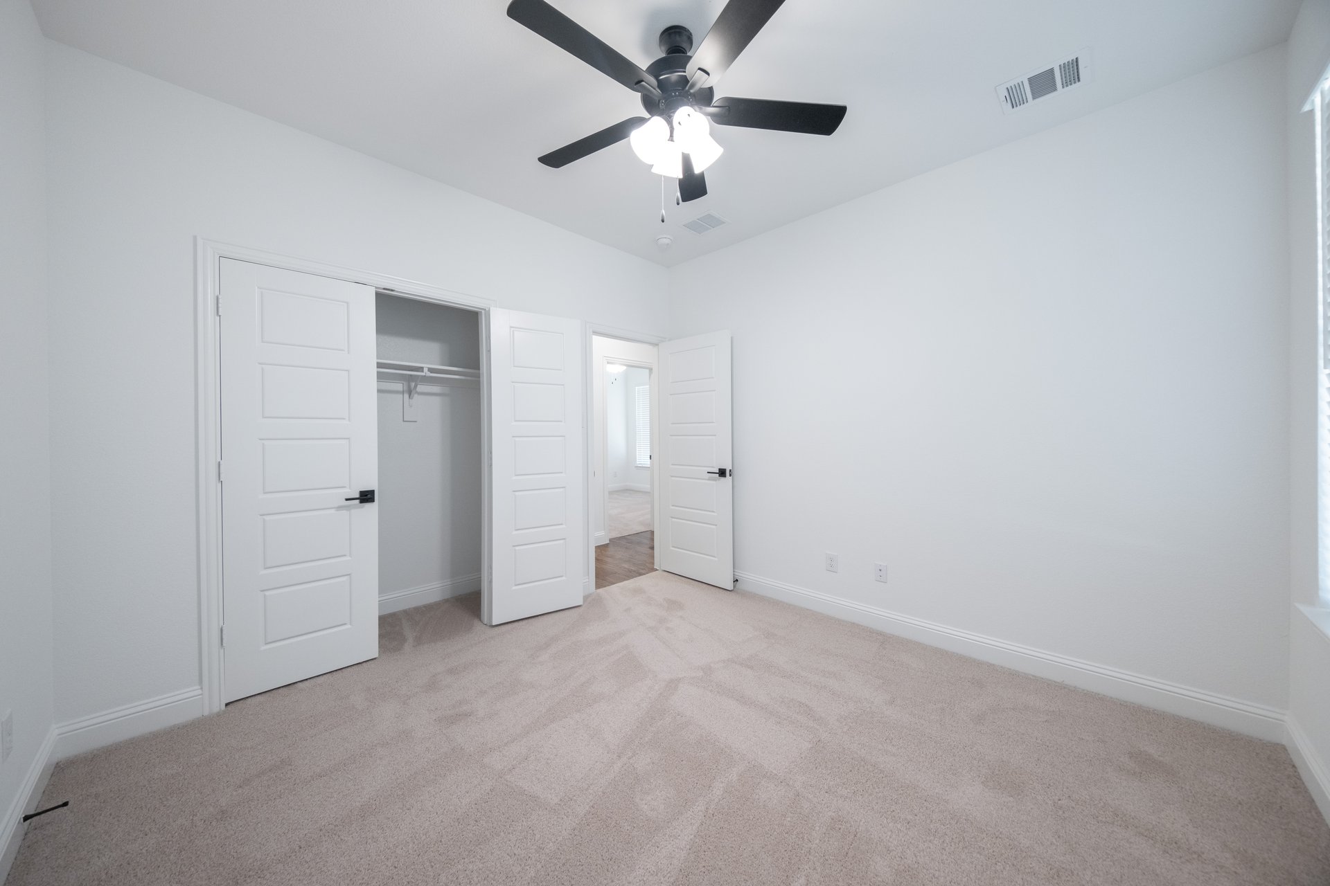 guest bedroom with carpet and walk-in closet