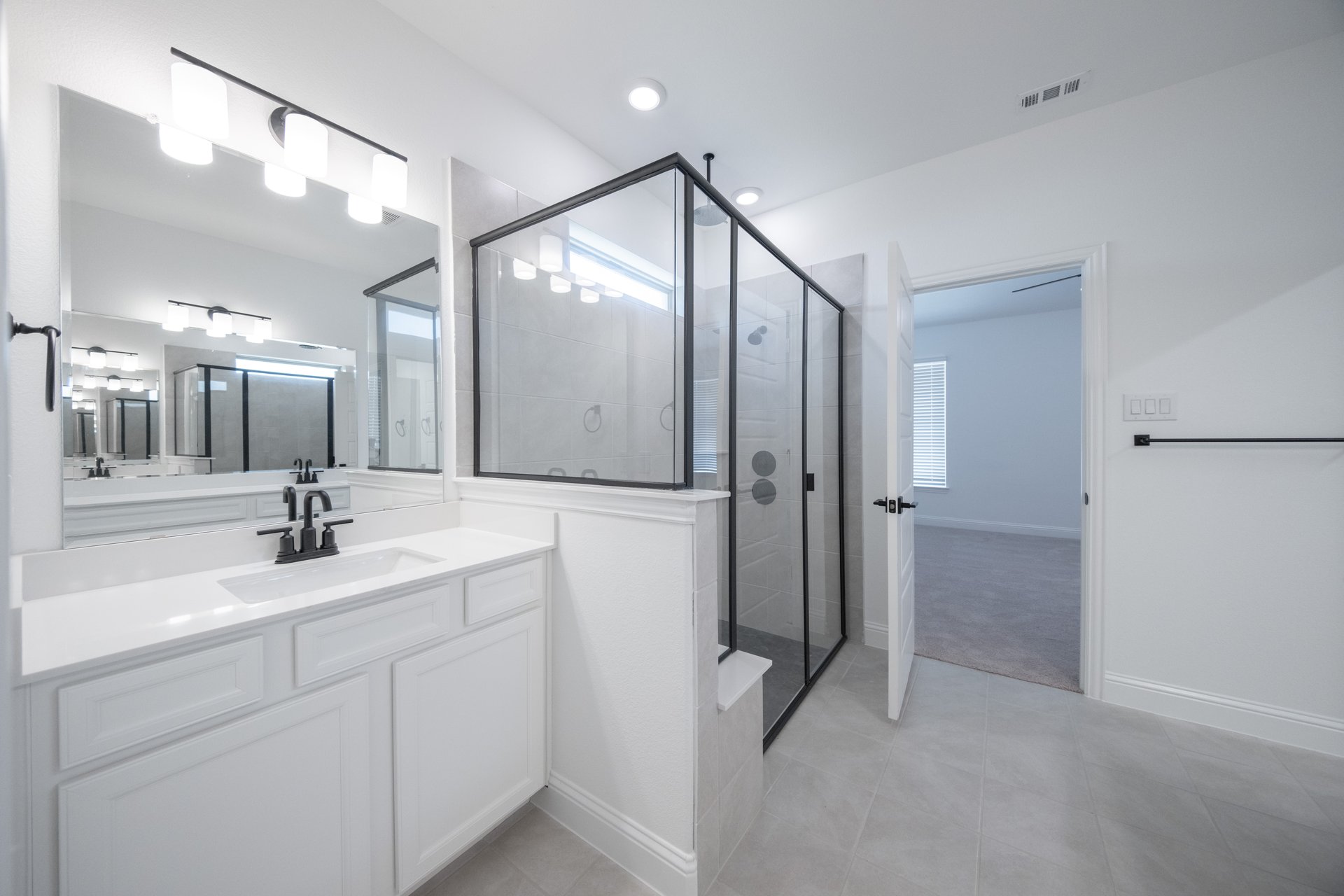 spacious primary bathroom with walk-in shower