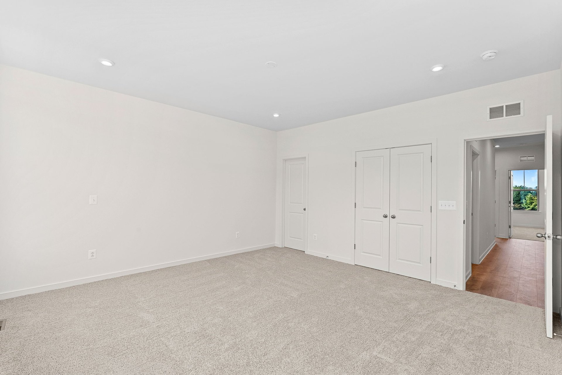 secondary bedroom with doors to closet and hallway