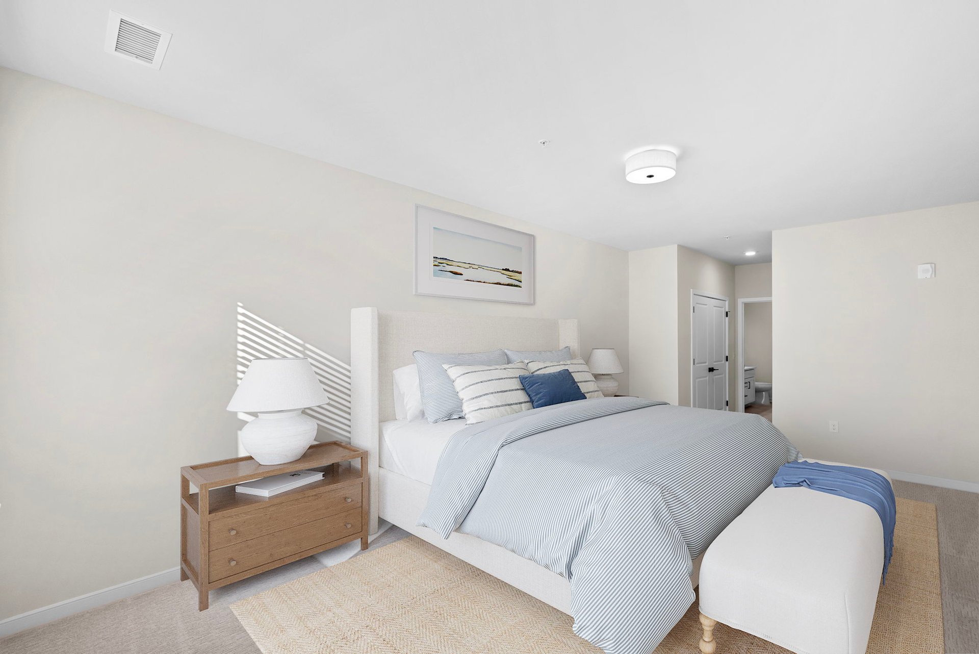 secondary bedroom with nightstand, bed, and ottoman 