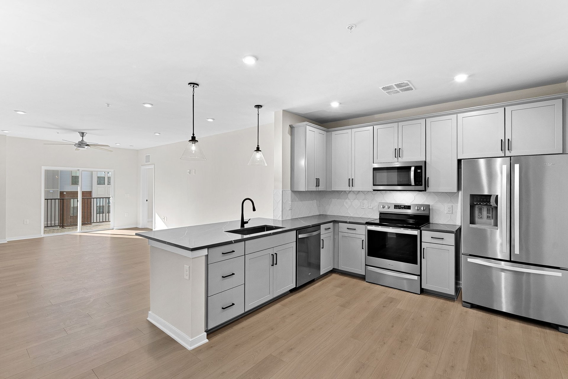 kitchen with quartz countertops and gray cabinets