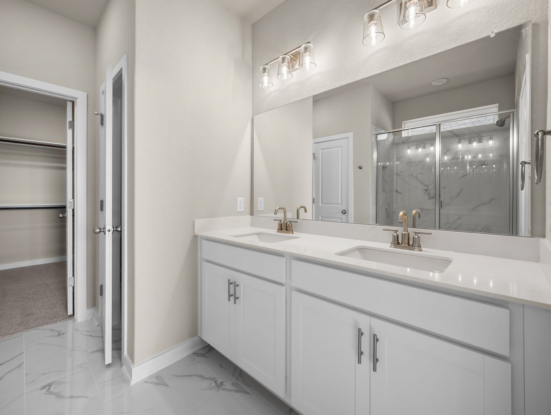 bathroom with dual sinks & a walk-in shower