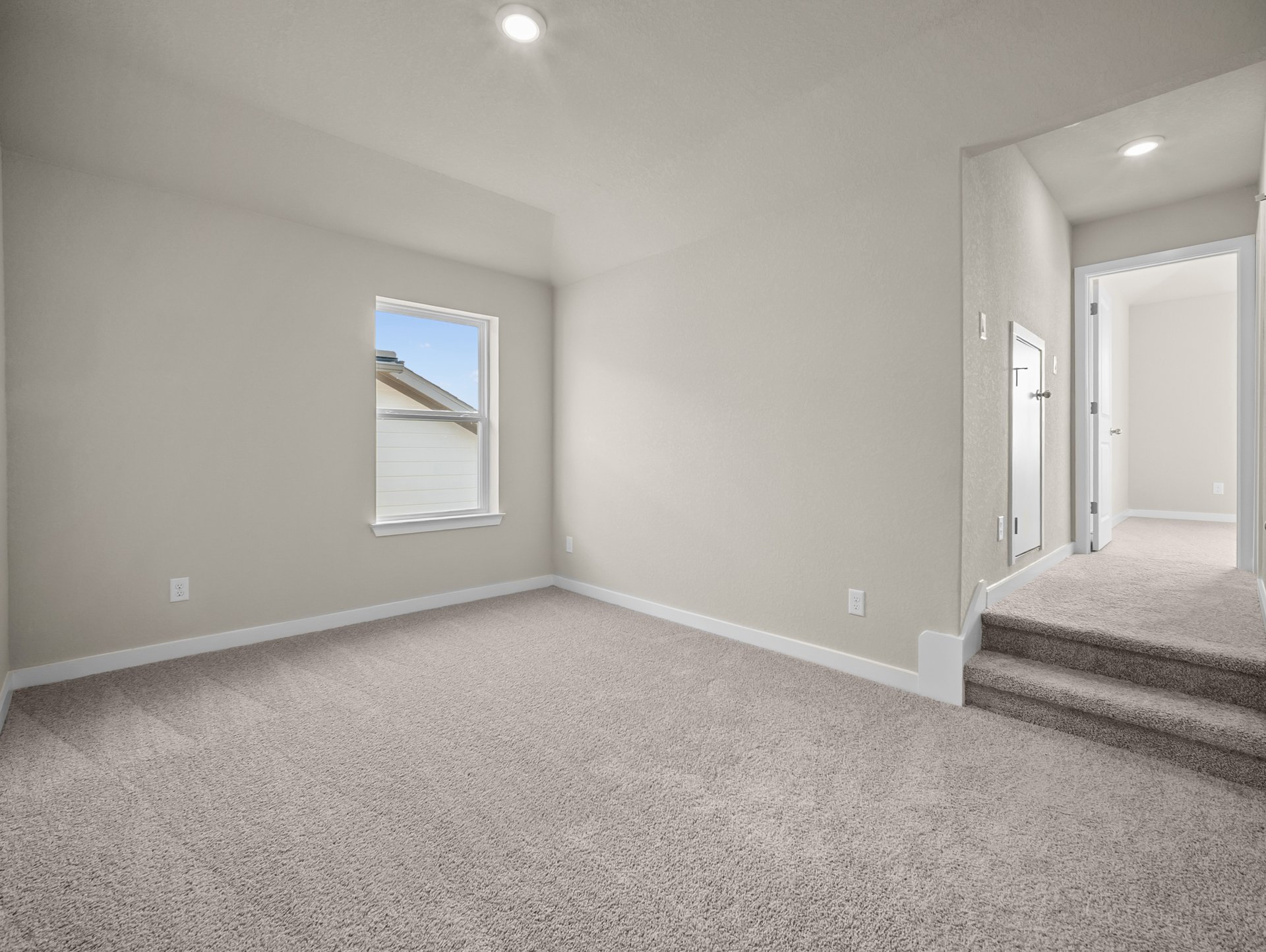loft with carpet, windows & a sloped ceiling
