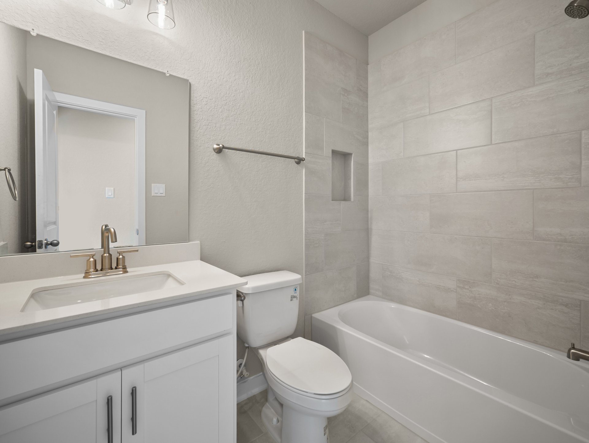 bathroom with quartz countertops & a bathtub with shower combo