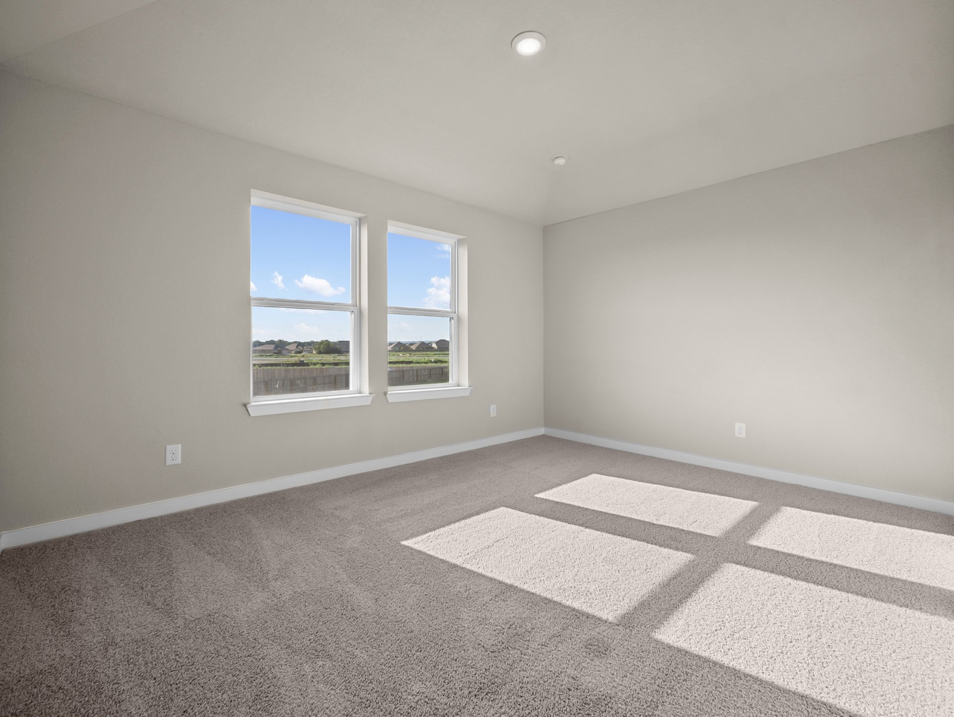 bedroom with carpet, windows & a sloped ceiling