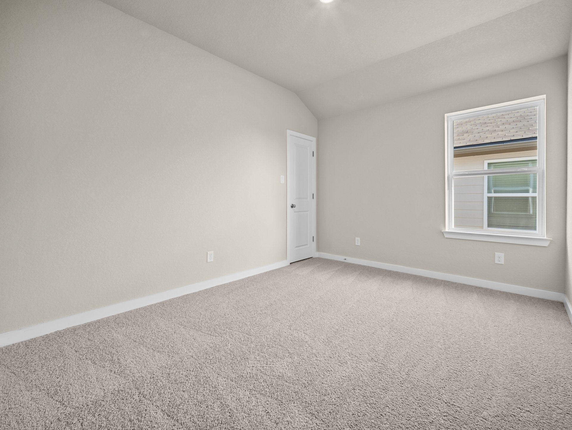 bedroom with carpet, sloped ceiling & a window