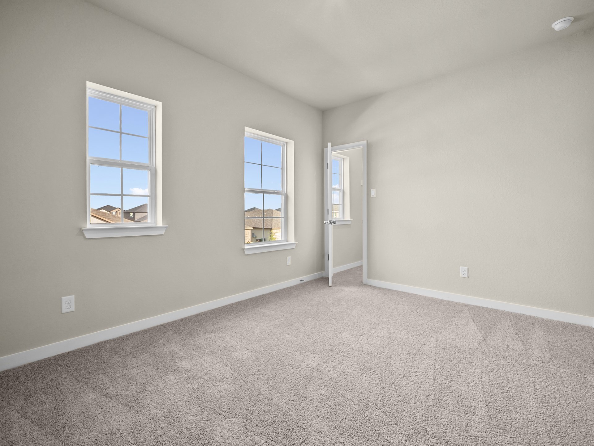 bedroom with carpet, a window & a sloped ceiling