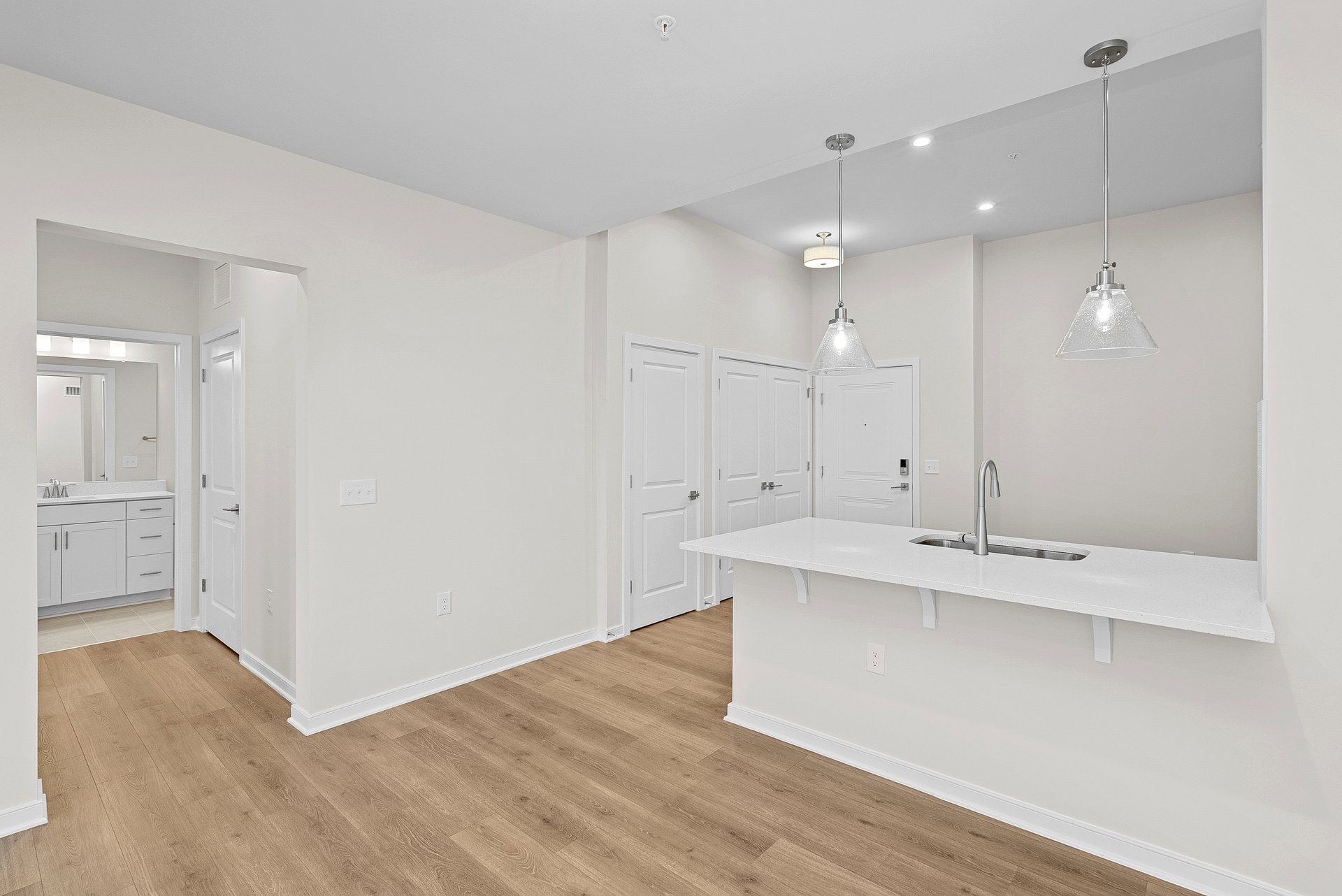 kitchen with quartz countertops and pendant lighting 