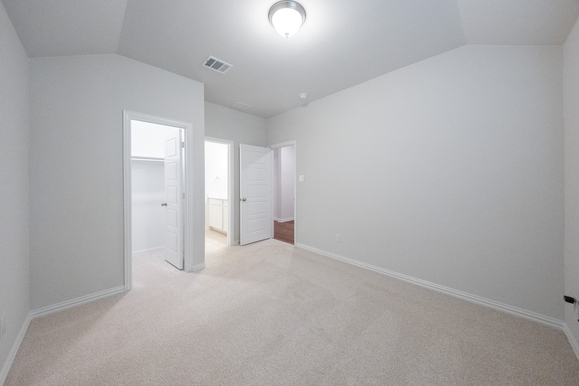 guest bedroom with carpet and walk-in closet