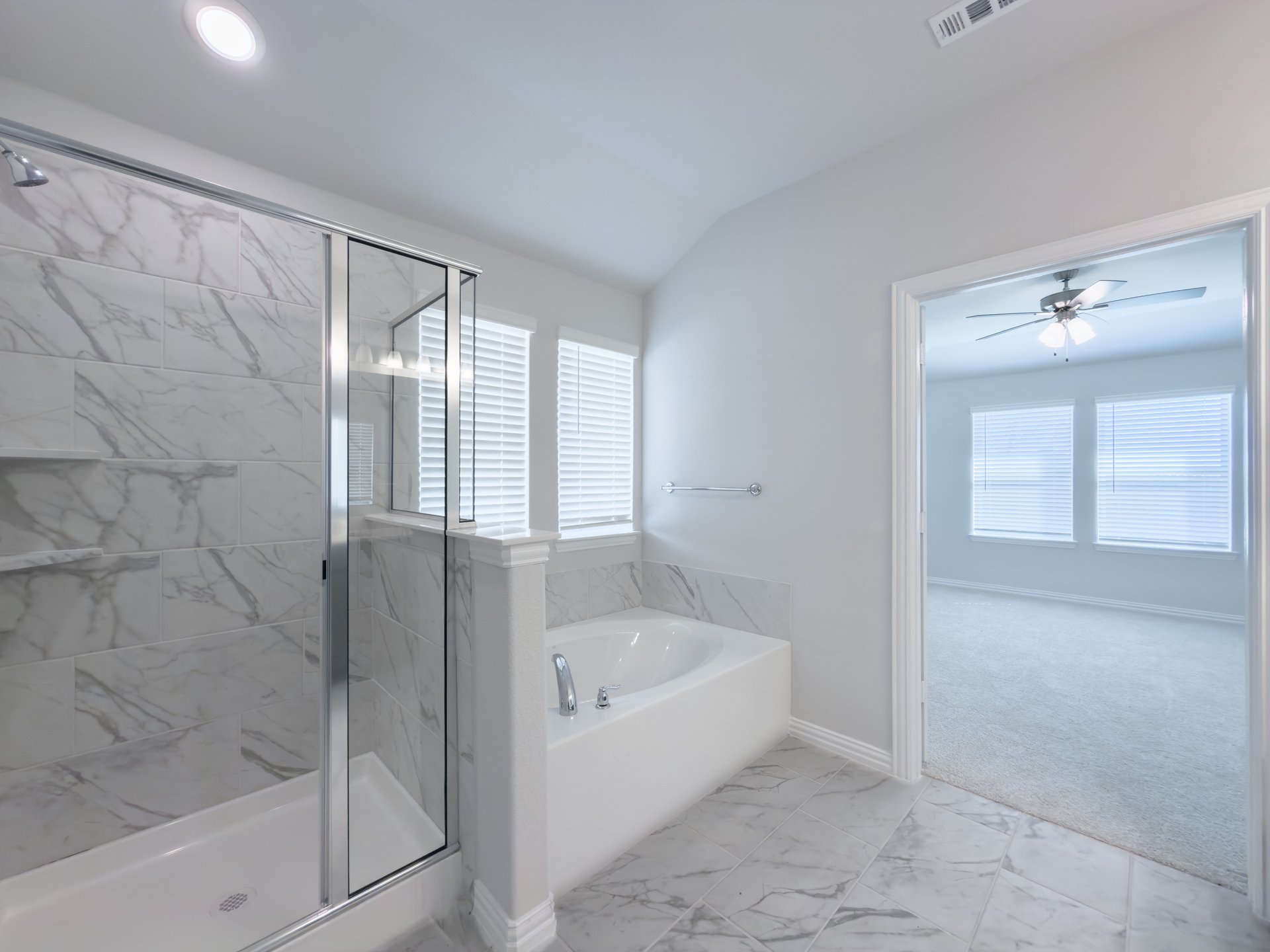 bathroom with large soaking tub and walk-in shower 