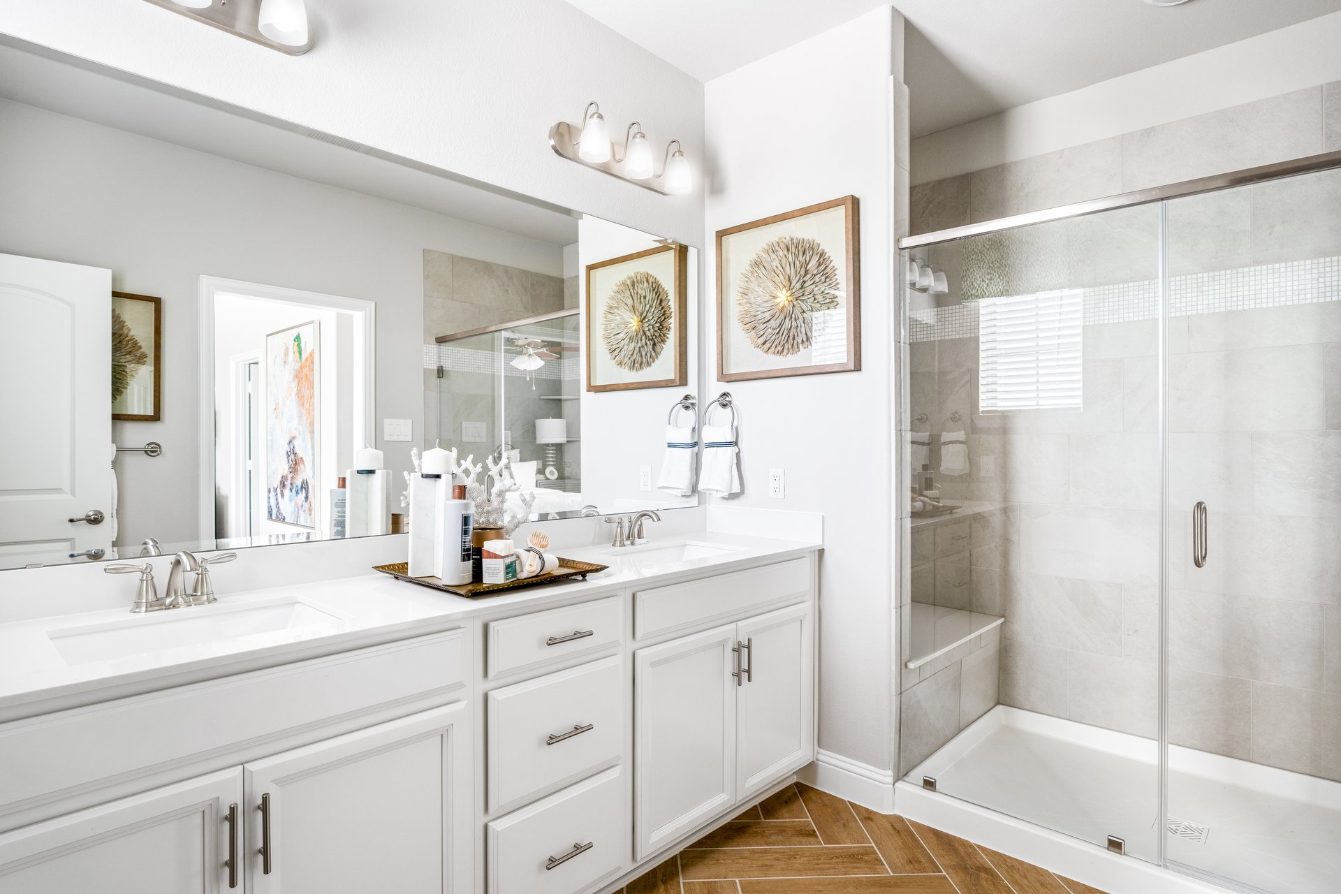 bathroom with walk-in shower and white cabinets 