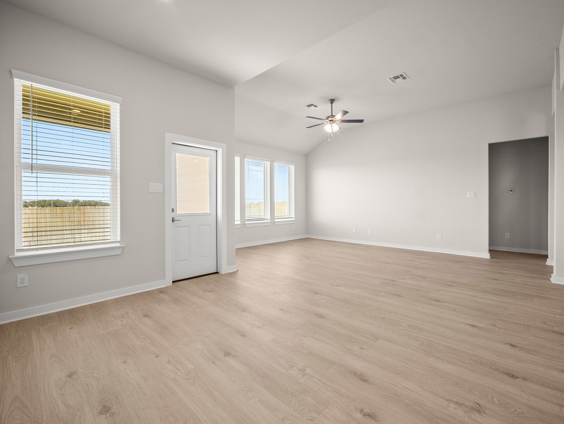 great room with a window, recessed lighting & brown flooring