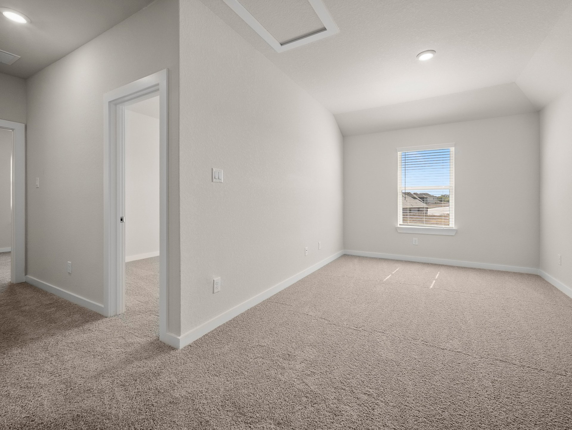 loft with carpet, recessed lighting & a window