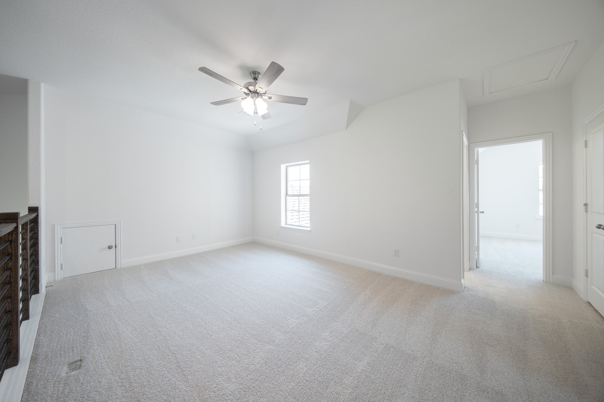 spacious game room with carpet and ceiling fan