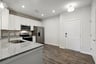kitchen with quartz countertops and white cabinets