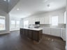 open kitchen with white cabinets and hardwood flooring
