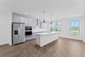 kitchen with an island with a sink and pendant lighting
