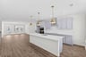 kitchen with an island with a sink and pendant lighting