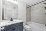 secondary bathroom with a tub/shower combo
