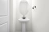 bathroom with mirror and sink and faucet underneath