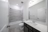 bathroom with tub and tile 