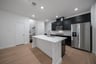kitchen with large island and black cabinets 