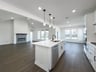 open kitchen with wood floors and white cabinets