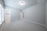guest bedroom with carpet and walk-in closet