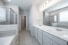 spacious primary bathroom with double sinks
