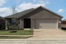 exterior of home with dark brown brick
