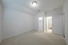 guest bedroom with carpet and walk-in closet