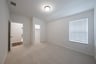 guest bedroom with carpet and walk-in closet