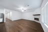 open great room with hardwood flooring and electric fireplace